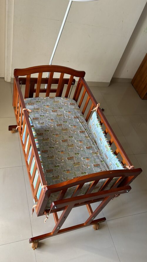 Babyhug Ionia wooden cradle with mosquito net cheery