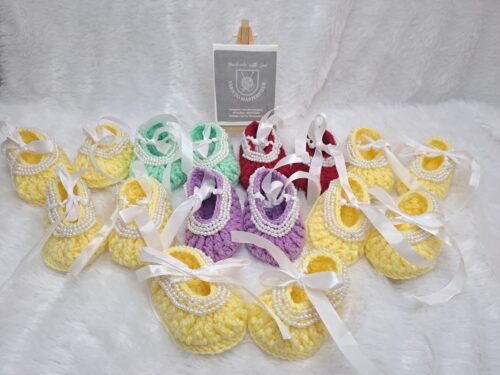 Crochet baby girl booties with beads.